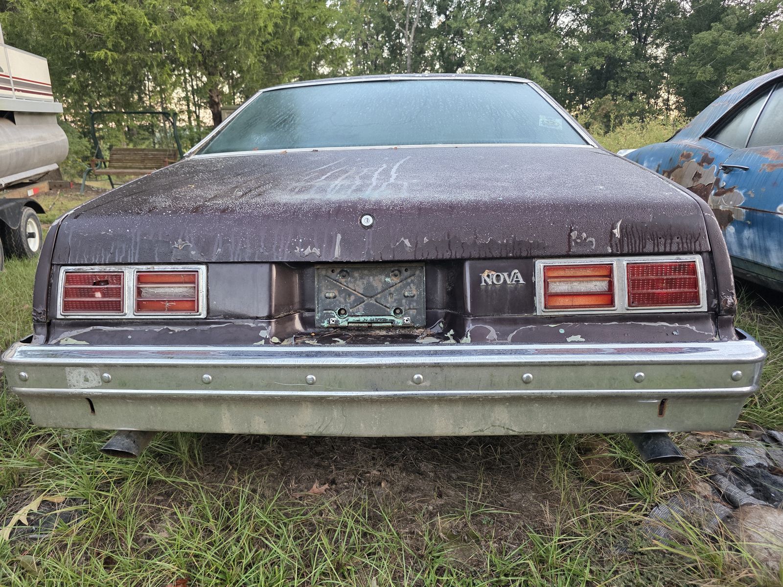 Rear of the 1974 Chevrolet Nova with peeling paint on the trunk lid and tail panel
